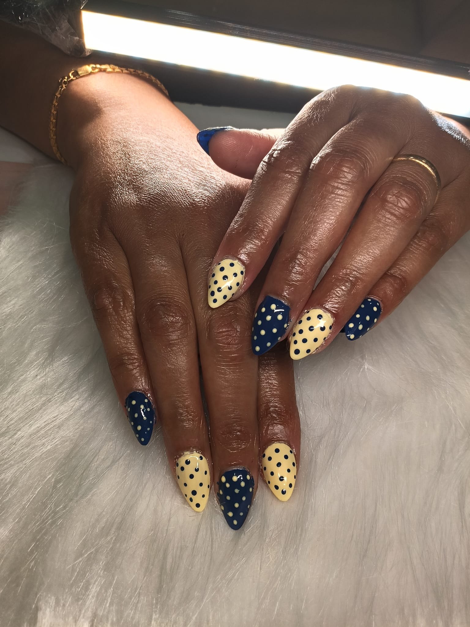 Navy & Pastel Lemon Polka — Sets by Ginni nail set worn on hands